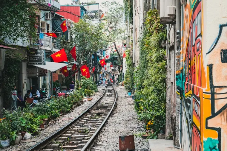 A narrow Hanoi street lined with Vietnamese flags